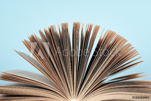 Picture of Book stacking Open book hardback books on wooden table and blue background Back to school Copy space for text